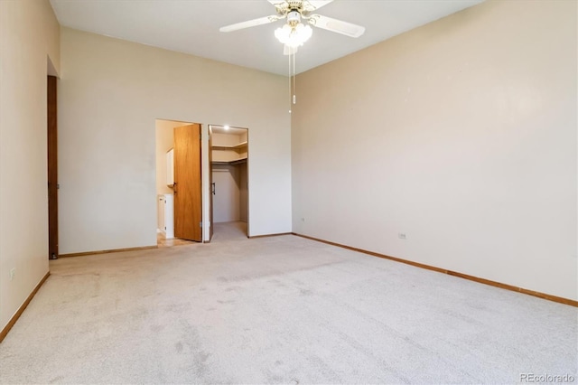 585 S Alton Way Unit 4D, Denver, CO 80247 - unfurnished bedroom featuring light colored carpet, a walk in closet, and a ceiling fan