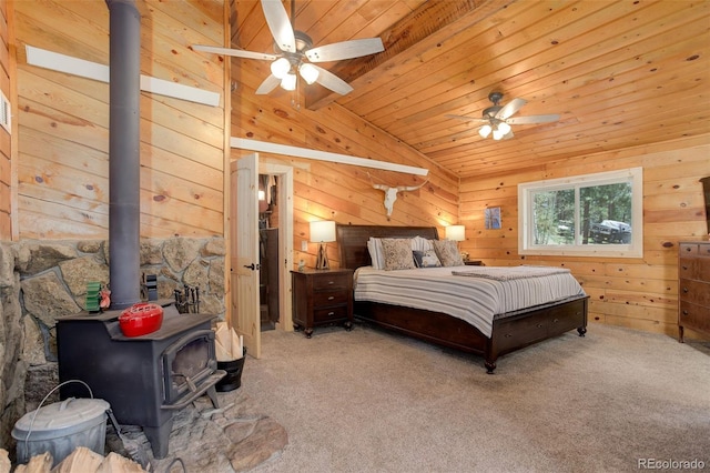 28251 Shadow Mountain Dr, Conifer, CO 80433 - carpeted bedroom with a wood stove, wooden walls, wood ceiling, vaulted ceiling, and a ceiling fan
