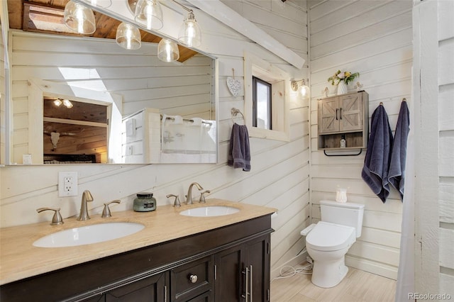 28251 Shadow Mountain Dr, Conifer, CO 80433 - full bath with wooden walls, double vanity, and toilet