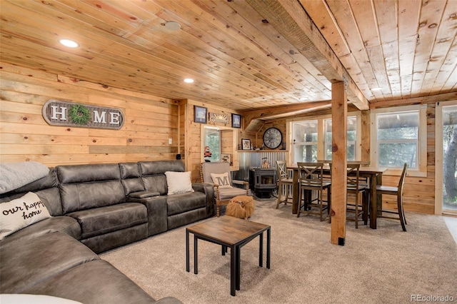28251 Shadow Mountain Dr, Conifer, CO 80433 - carpeted living room featuring a wood stove, wooden ceiling, wooden walls, and recessed lighting
