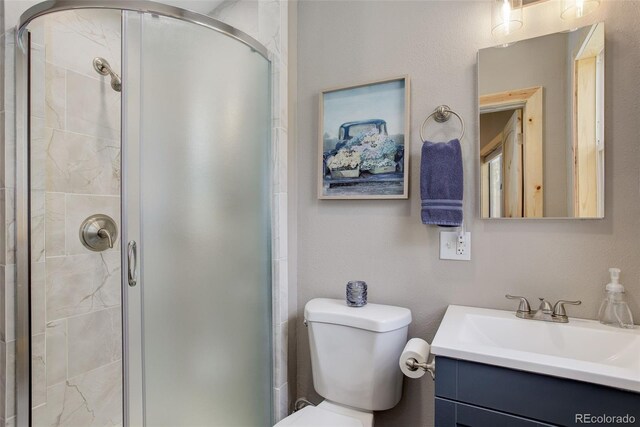 28251 Shadow Mountain Dr, Conifer, CO 80433 - bathroom featuring vanity, a shower stall, and toilet