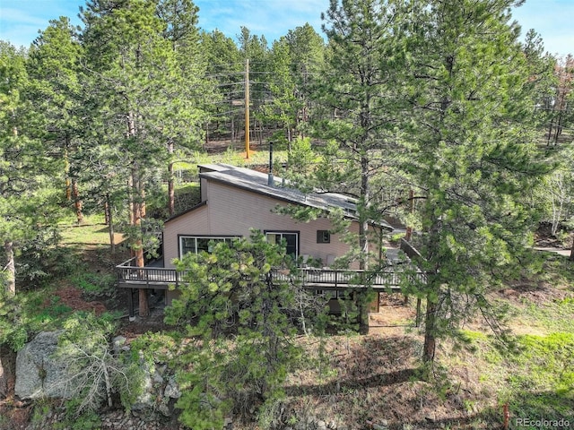 28251 Shadow Mountain Dr, Conifer, CO 80433 - view of property exterior featuring a wooden deck and a wooded view