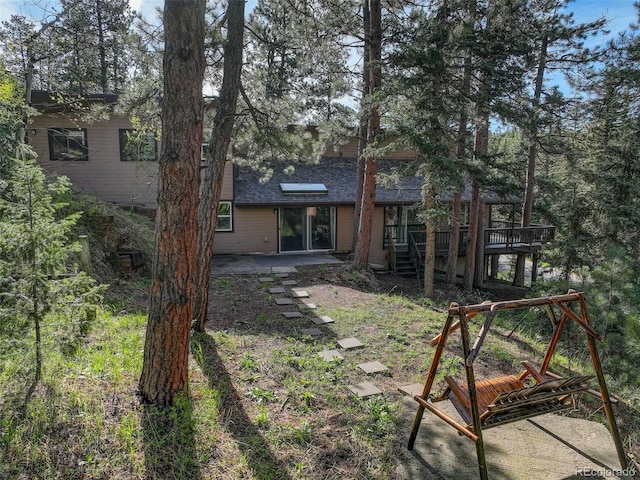 28251 Shadow Mountain Dr, Conifer, CO 80433 - rear view of property featuring a patio, a wooden deck, roof with shingles, and stairway