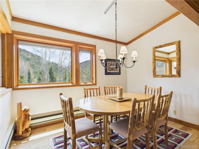 620 Tennis Club Rd Unit 1339, Dillon, CO 80435 - dining space featuring a baseboard radiator, a chandelier, lofted ceiling, and wood finished floors