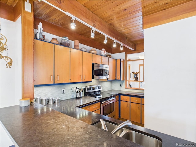620 Tennis Club Rd Unit 1339, Dillon, CO 80435 - kitchen with stainless steel appliances, track lighting, wooden ceiling, dark countertops, and backsplash