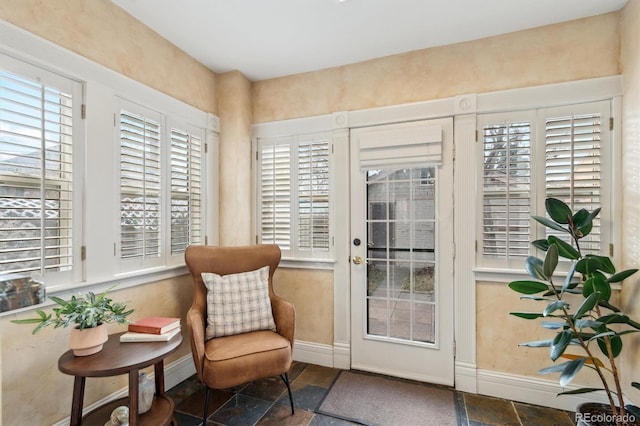 entryway featuring stone tile flooring and baseboards