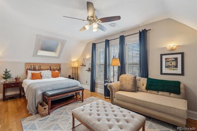 bedroom featuring vaulted ceiling, wood finished floors, a ceiling fan, and baseboards