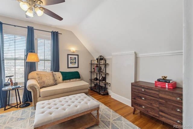 sitting room featuring lofted ceiling, ceiling fan, wood finished floors, and baseboards