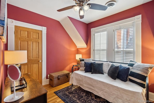 bedroom with light wood-type flooring, visible vents, and a ceiling fan