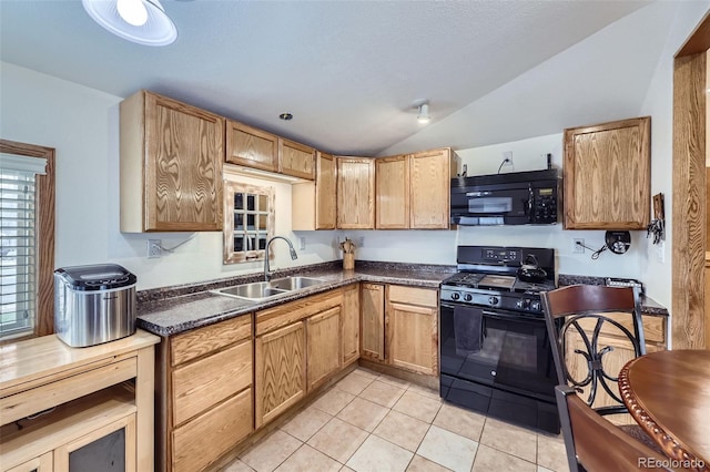 195 Briggs St, Erie, CO 80516 - kitchen featuring light tile patterned floors, lofted ceiling, a sink, black appliances, and dark countertops
