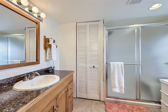 195 Briggs St, Erie, CO 80516 - full bath featuring vanity, visible vents, a closet, and a stall shower