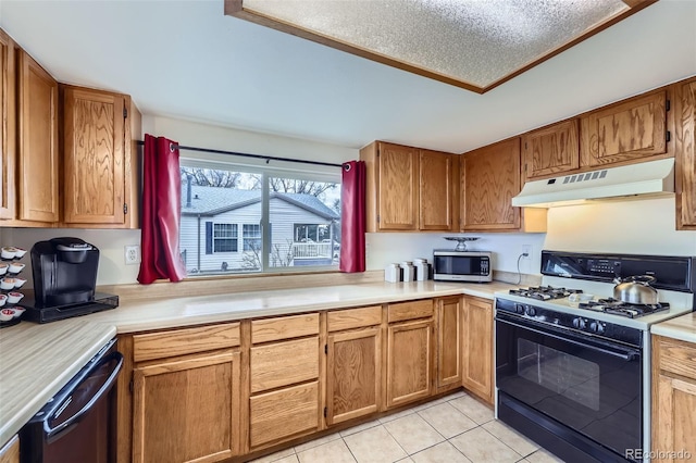 195 Briggs St, Erie, CO 80516 - kitchen featuring light tile patterned floors, light countertops, under cabinet range hood, gas range, and stainless steel microwave