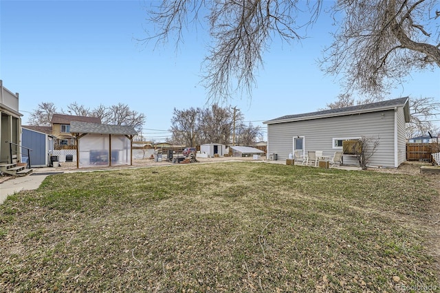 195 Briggs St, Erie, CO 80516 - view of yard featuring an outdoor structure, a storage unit, and fence