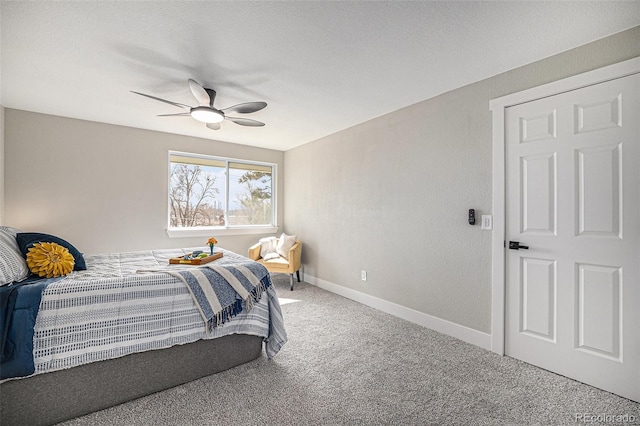 carpeted bedroom with a textured ceiling, a ceiling fan, and baseboards