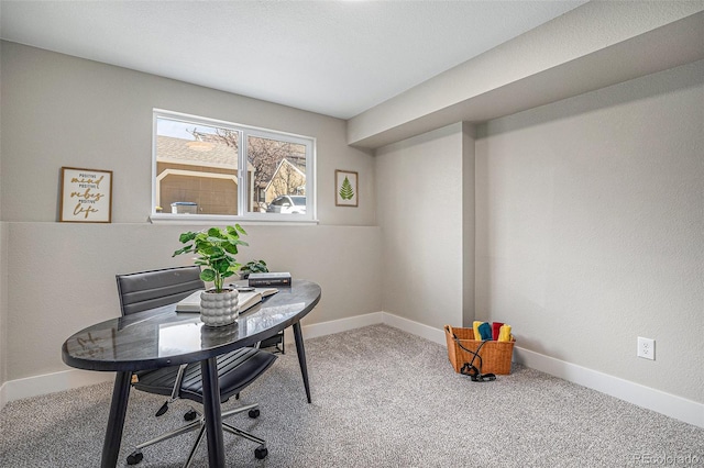 carpeted office space featuring baseboards