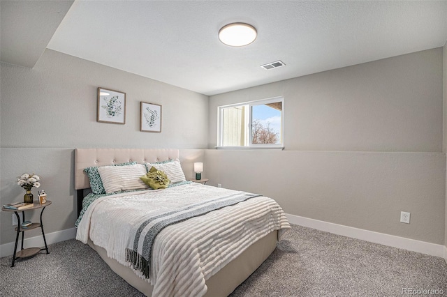 carpeted bedroom featuring visible vents and baseboards