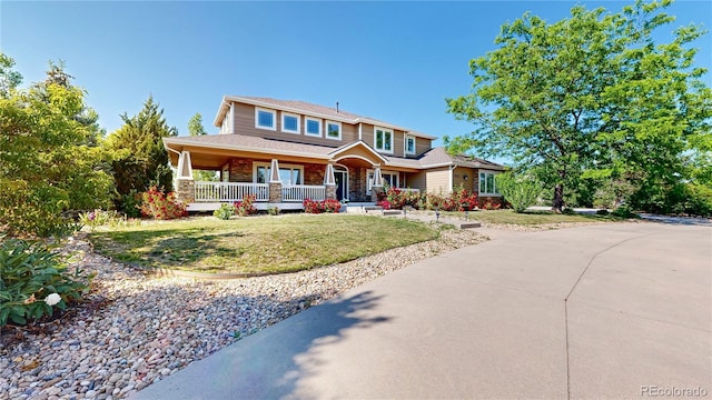 9353 E 146th Ave, Brighton, CO 80602 - view of front of property featuring a porch and a front yard