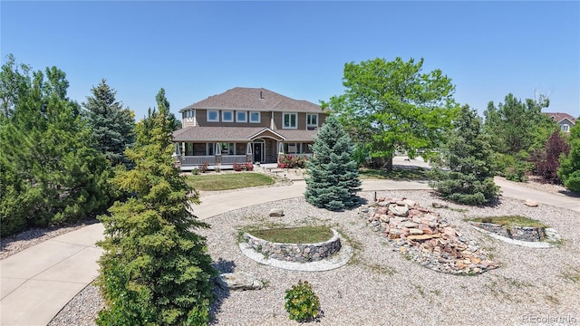 9353 E 146th Ave, Brighton, CO 80602 - view of front of home with a porch and curved driveway