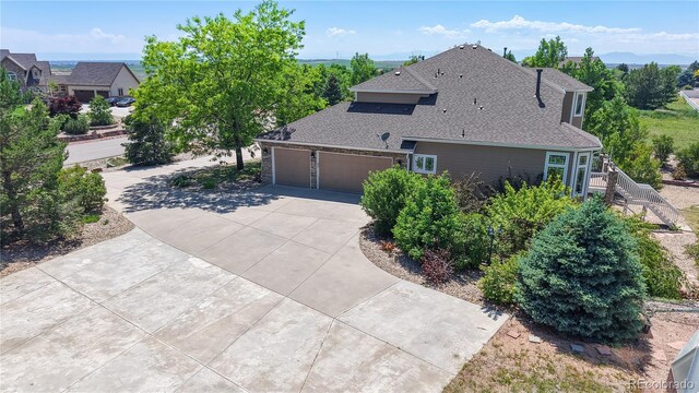 9353 E 146th Ave, Brighton, CO 80602 - view of home's exterior featuring roof with shingles, driveway, and an attached garage