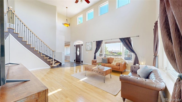 9353 E 146th Ave, Brighton, CO 80602 - living area with wood finished floors, a high ceiling, stairway, and a ceiling fan