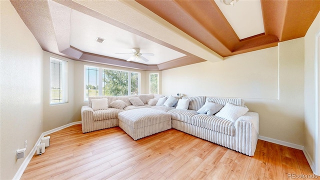 9353 E 146th Ave, Brighton, CO 80602 - living room with a tray ceiling, ceiling fan, and light wood-style flooring