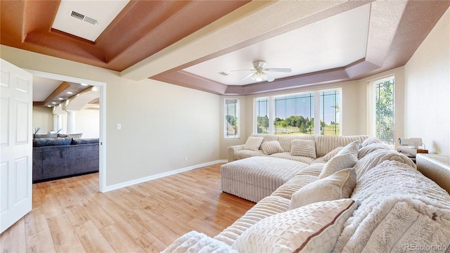 9353 E 146th Ave, Brighton, CO 80602 - living area with a raised ceiling, light wood-type flooring, and a ceiling fan