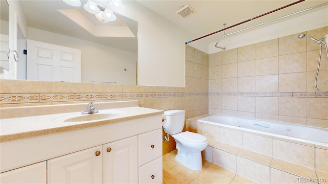 9353 E 146th Ave, Brighton, CO 80602 - bathroom with tile walls, tile patterned flooring, tiled shower / bath combo, and vanity