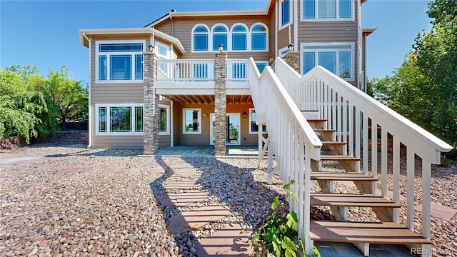 9353 E 146th Ave, Brighton, CO 80602 - back of property featuring stairway and a wooden deck