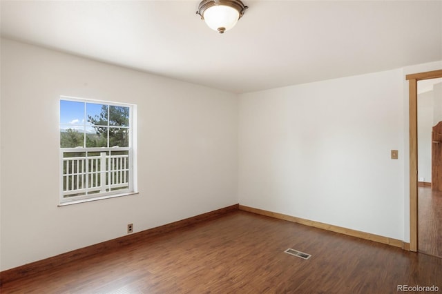 unfurnished room with wood finished floors and baseboards