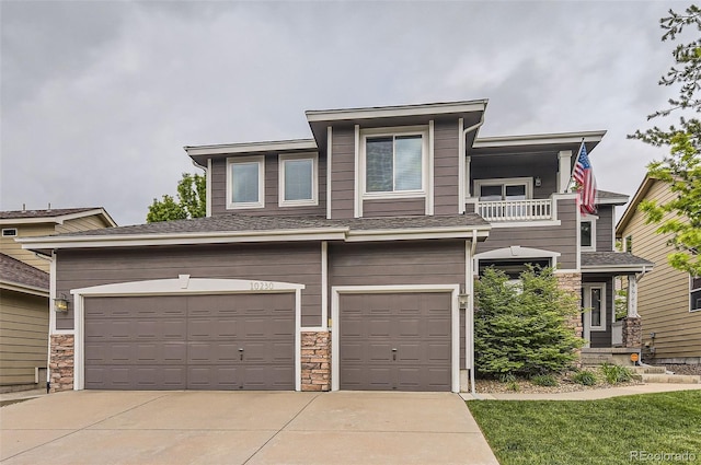 10230 Lauren Ct, Highlands Ranch, CO 80130 - view of front of home with a balcony, a garage, stone siding, and driveway