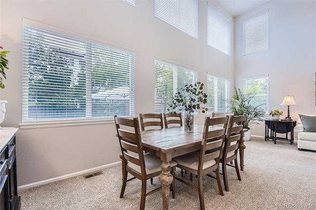 10230 Lauren Ct, Highlands Ranch, CO 80130 - dining area featuring light colored carpet, baseboards, and a high ceiling