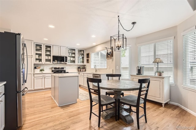 10230 Lauren Ct, Highlands Ranch, CO 80130 - dining space with light wood-style flooring, a chandelier, recessed lighting, and baseboards