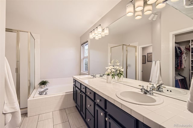 10230 Lauren Ct, Highlands Ranch, CO 80130 - bathroom with a stall shower, double vanity, a bath, a walk in closet, and vaulted ceiling