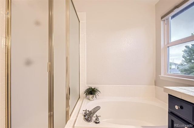 10230 Lauren Ct, Highlands Ranch, CO 80130 - bathroom featuring a stall shower, a garden tub, and vanity