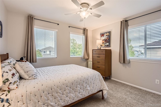 10230 Lauren Ct, Highlands Ranch, CO 80130 - carpeted bedroom featuring multiple windows, baseboards, and ceiling fan