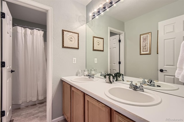 10230 Lauren Ct, Highlands Ranch, CO 80130 - bathroom with double vanity, wood finished floors, and a shower with curtain