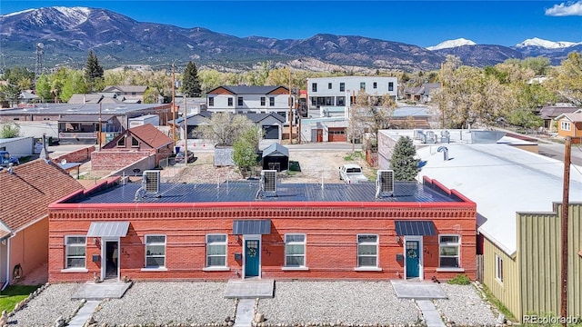 drone / aerial view featuring a residential view and a mountain view