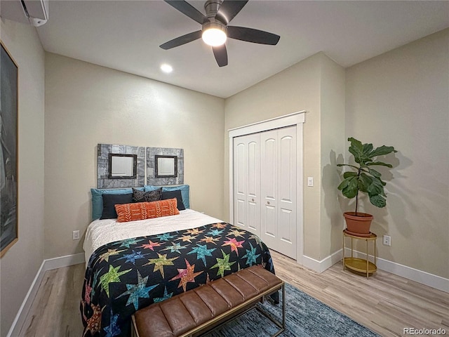 bedroom with a ceiling fan, a closet, baseboards, and wood finished floors