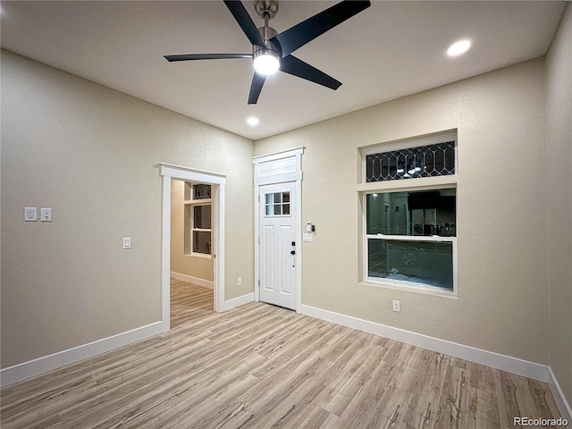 empty room featuring a ceiling fan, baseboards, wood finished floors, and recessed lighting