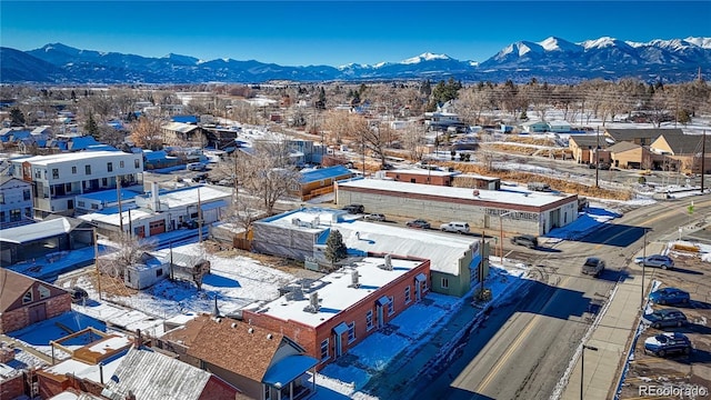 snowy aerial view with a mountain view