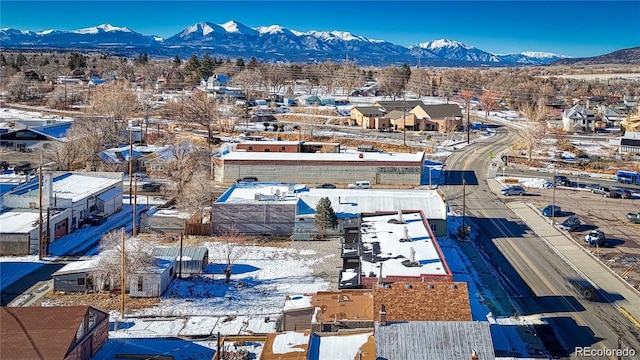 snowy aerial view featuring a mountain view