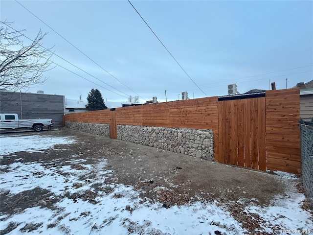 yard covered in snow with fence