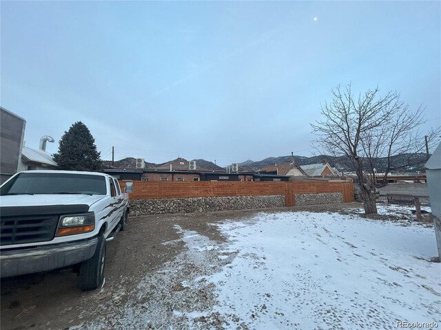 yard covered in snow with fence