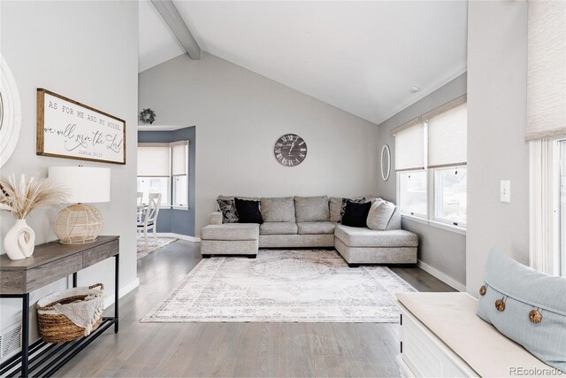 6386 S Pierson St, Littleton, CO 80127 - living area with beamed ceiling, wood finished floors, plenty of natural light, baseboards, and high vaulted ceiling