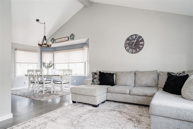 6386 S Pierson St, Littleton, CO 80127 - living room with a chandelier, high vaulted ceiling, wood finished floors, beam ceiling, and baseboards
