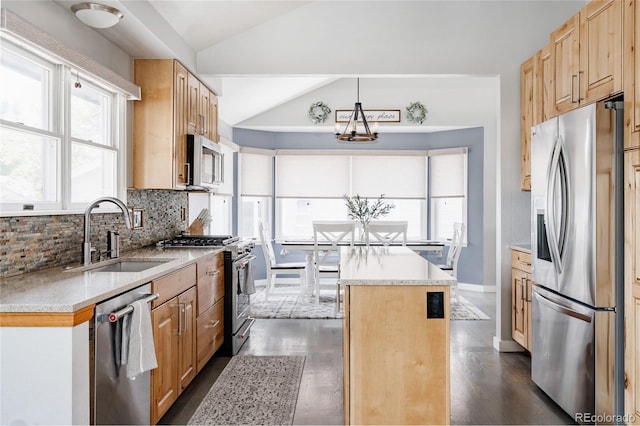 6386 S Pierson St, Littleton, CO 80127 - kitchen with stainless steel appliances, a sink, a kitchen island, lofted ceiling, and light countertops