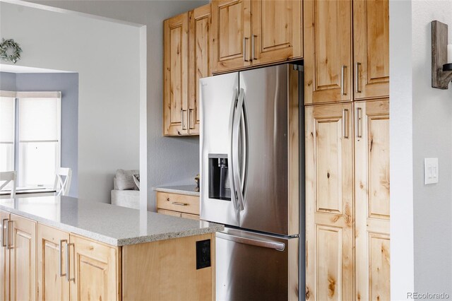 6386 S Pierson St, Littleton, CO 80127 - kitchen featuring stainless steel fridge, light brown cabinets, light stone countertops, and a center island