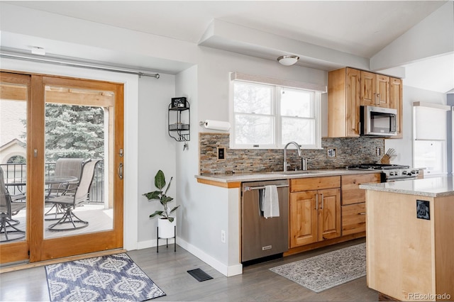 6386 S Pierson St, Littleton, CO 80127 - kitchen featuring appliances with stainless steel finishes, a sink, backsplash, wood finished floors, and light countertops
