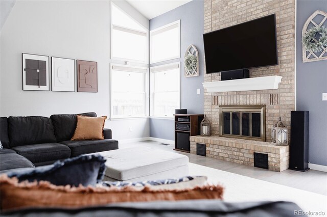 6386 S Pierson St, Littleton, CO 80127 - living room with baseboards, a fireplace, wood finished floors, and a high ceiling