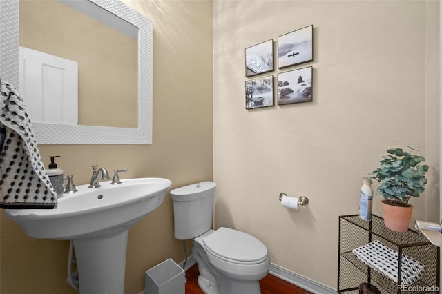 4887 Raven Run, Broomfield, CO 80023 - half bath with toilet, wood finished floors, and baseboards